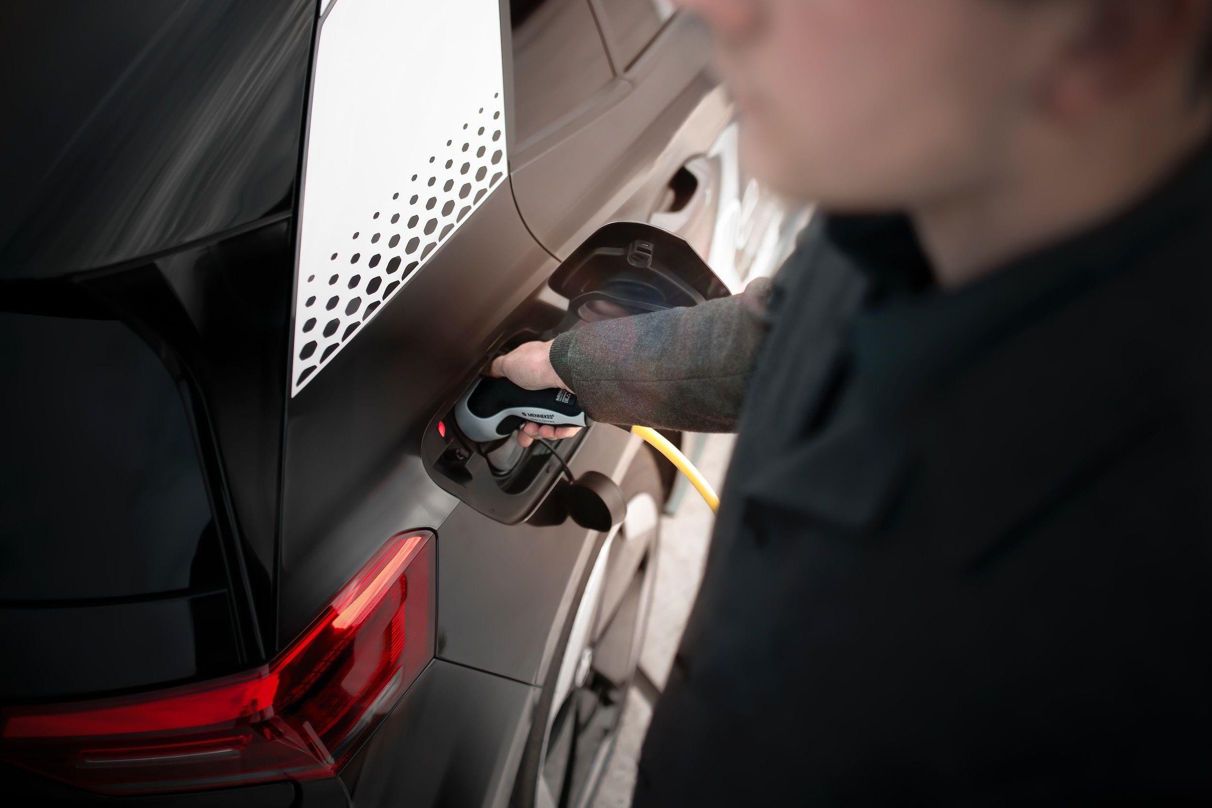 A man charging a car
