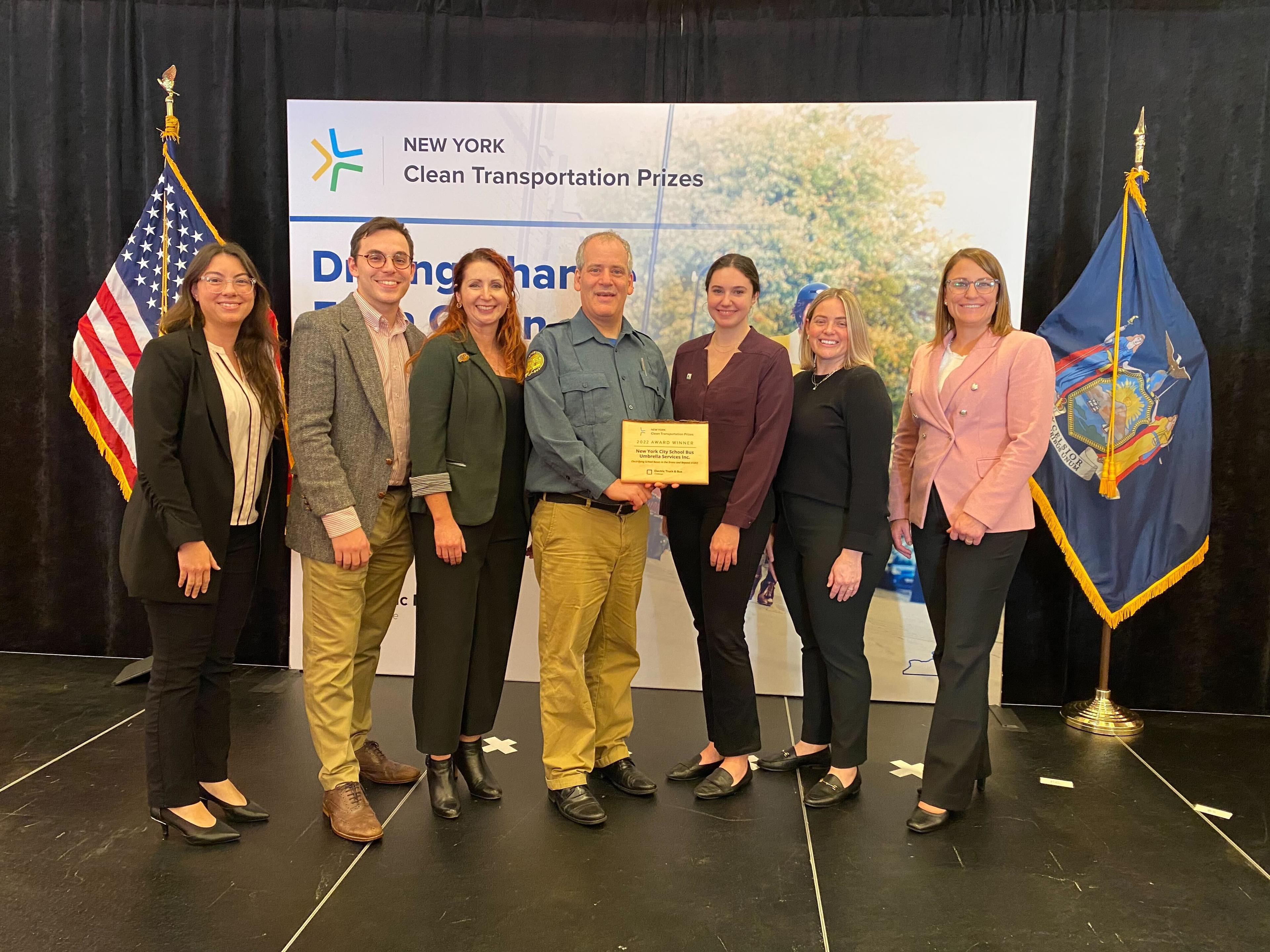 The project team accepts the grand prize from NYSERDA to electrify school buses in the bronx