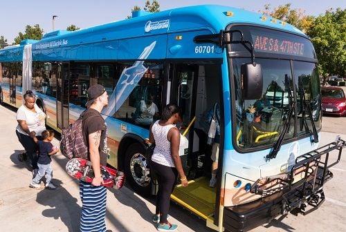 Passengers board a zero emissions electric bus