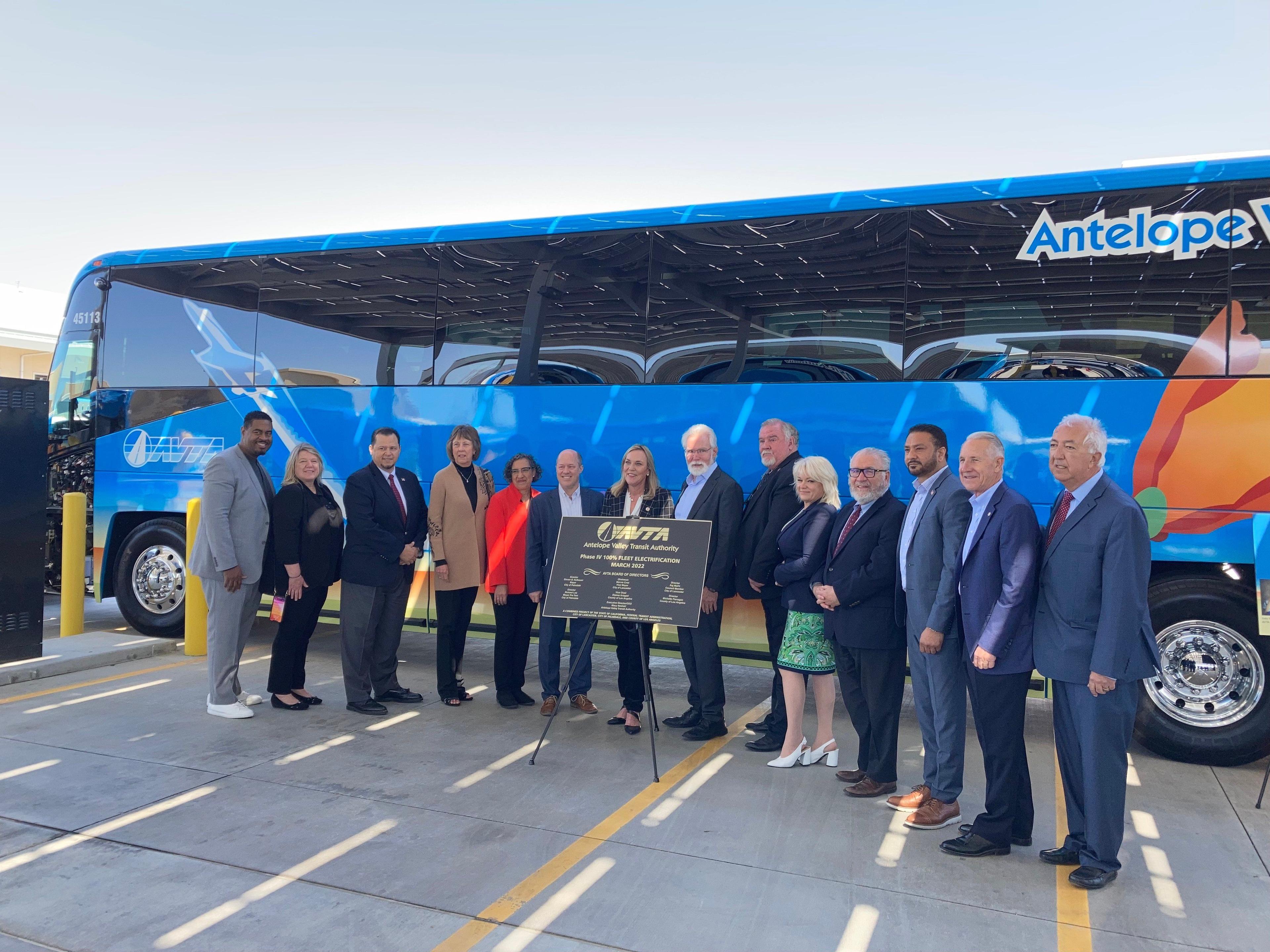 Officials from AVTA, CARB, Los Angeles County, City of Lancaster, and California State Transportation Agency gather in front of AVTA's new electric bus. 