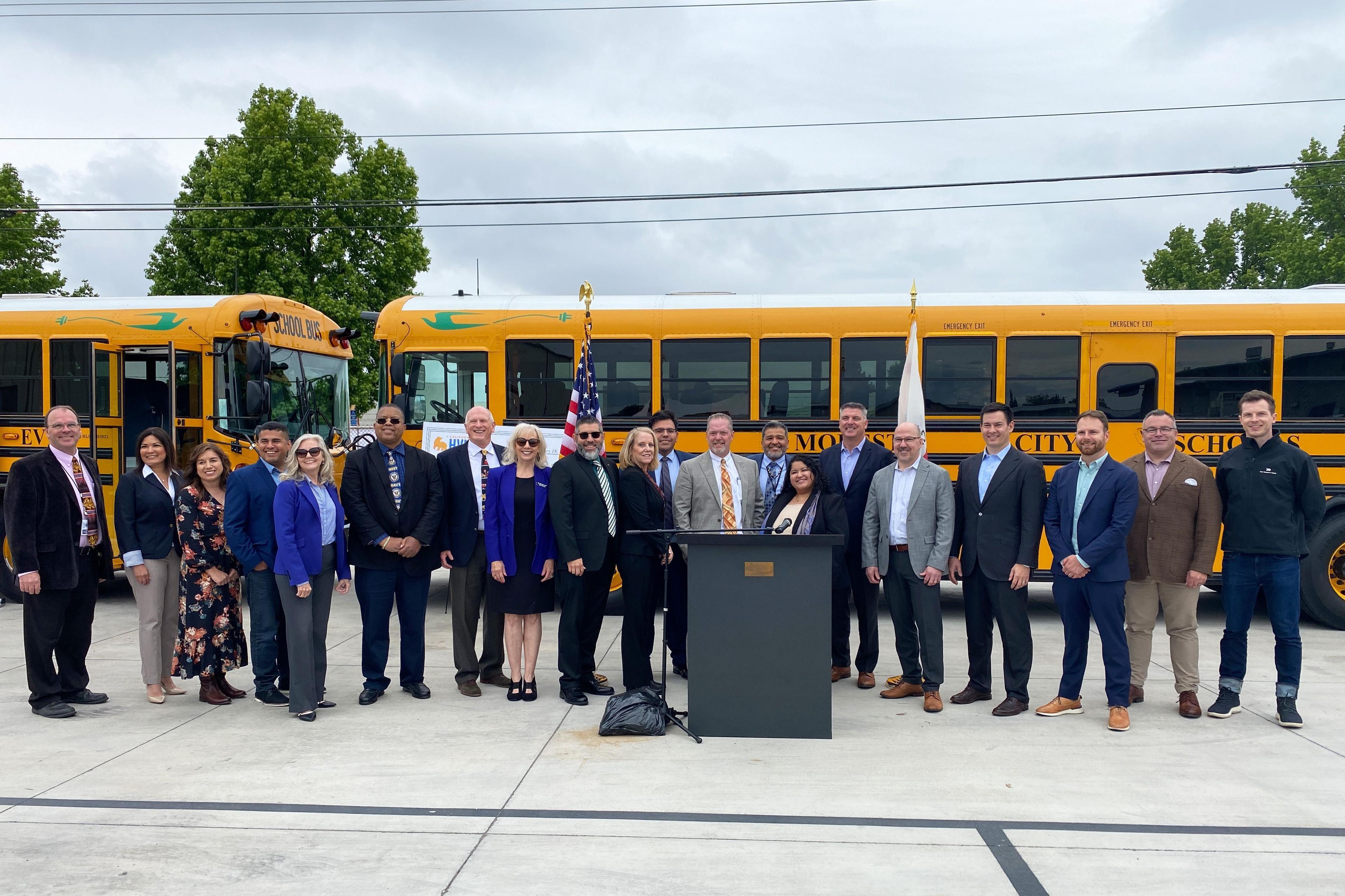 Modesto City Schools team in front of electric school bus