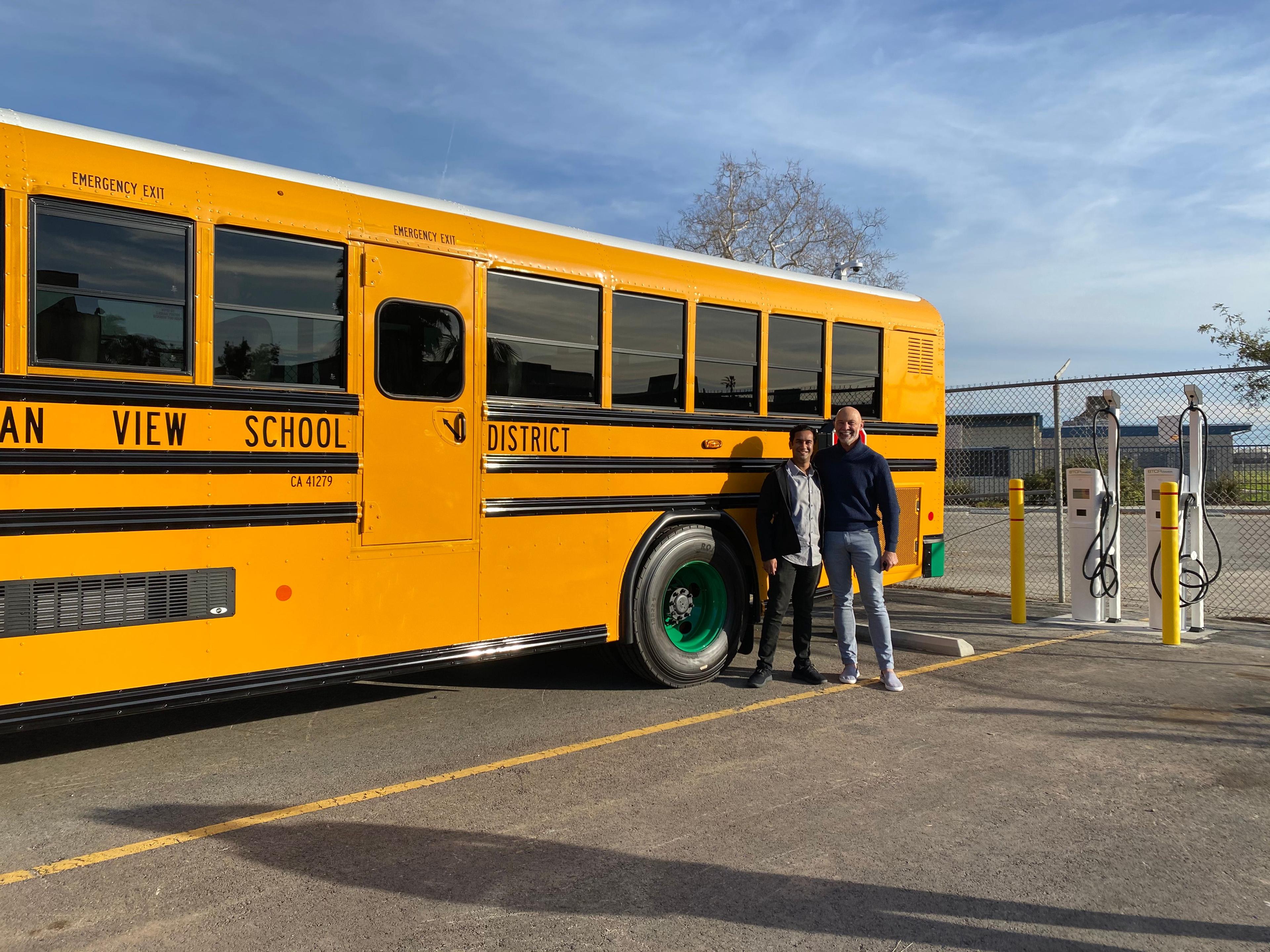 yellow school bus two people