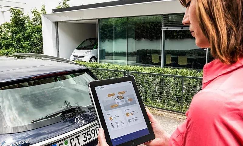 Woman operates a tablet in front of her car
